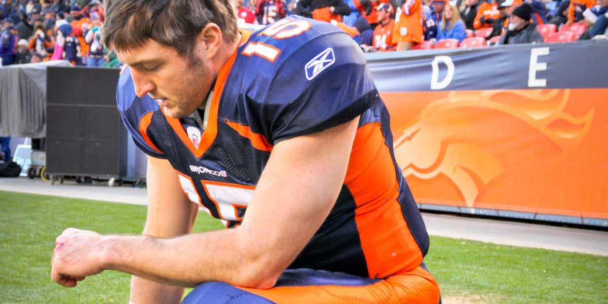 Photo of Tim Tebow “Tebowing” taken on 1-1-2012 at Sports Authority Field at Mile High (Denver Colorado). Denver Broncos vs Kansas City Chiefs Photo was taken prior to the start of the 2nd half.