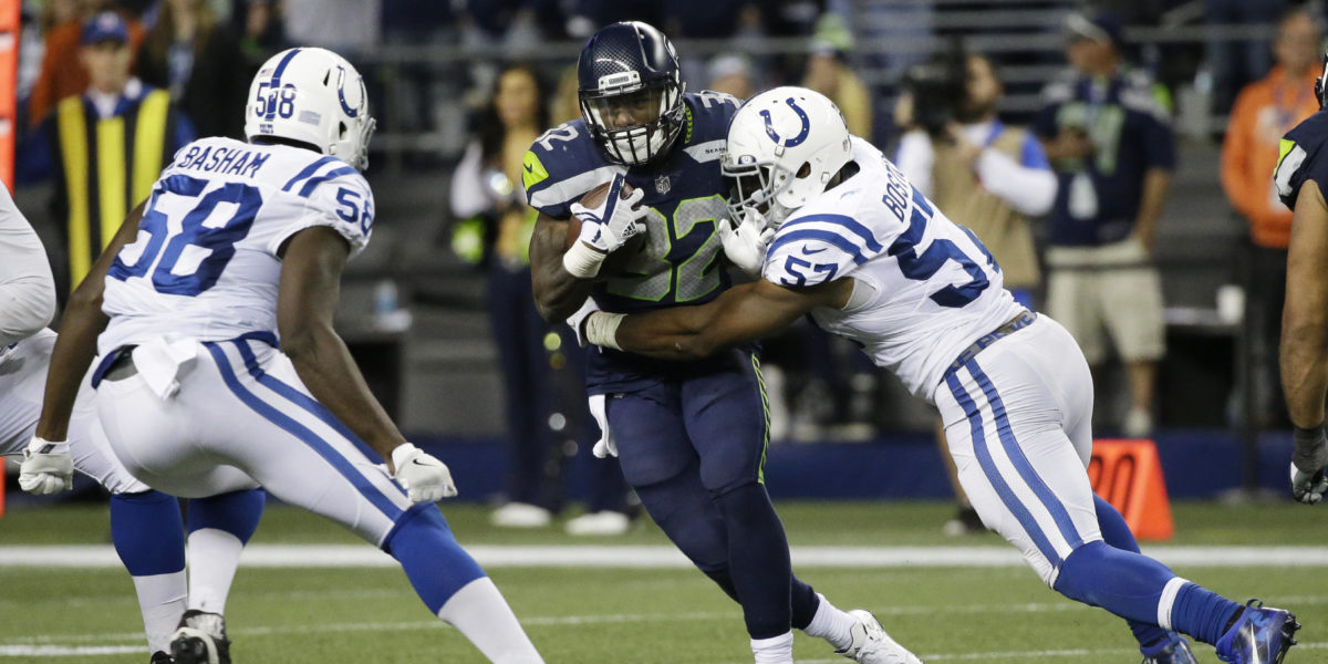 Indianapolis Colts linebacker Jon Bostic tackles Chris Carson of the Seattle Seahawks (2017 AP Photo/Elaine Thompson)