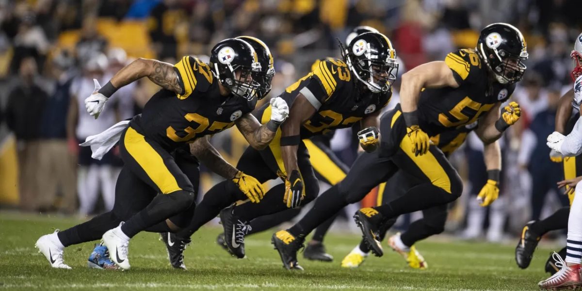 Jordan Dangerfield, Terrell Edmunds, and Anthony Chickillo of the Pittsburgh Steelers rush the New England Patriots offensive line (Dec. 16, 2018 - Karl Roser)