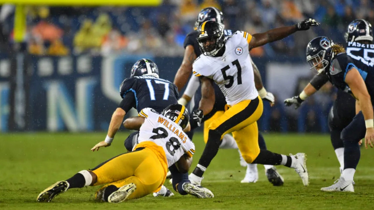 Pittsburgh Steelers outside linebacker Tuzar Skipper joins Vince Williams in bringing down the Tennessee Titans during preseason 2019