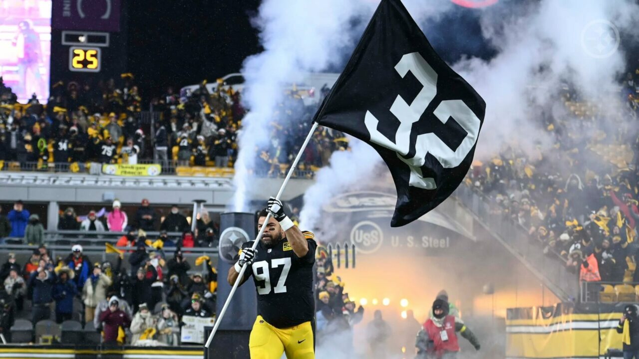 Cameron Heyward of the Pittsburgh Steelers carries a flag honoring Franco Harris