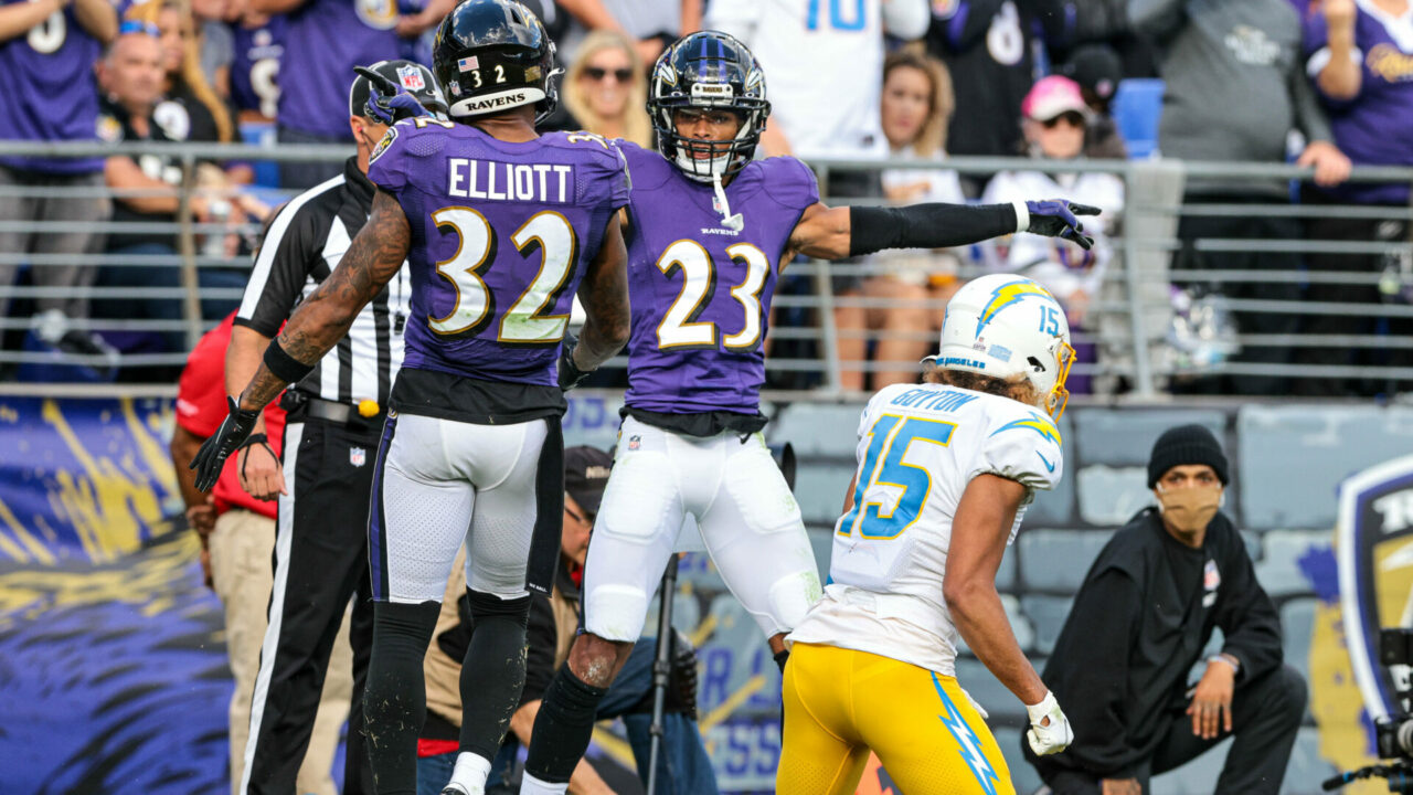 Baltimore Ravens cornerback Anthony Averett (23) celebrates a defensive stop with free safety DeShon Elliott (32) against Los Angeles Chargers wide receiver Jalen Guyton (15)
