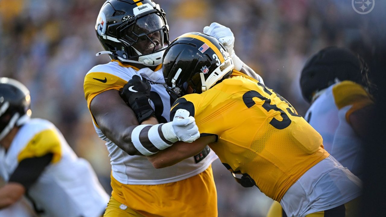 Jack Sawyer (33) and Darnell Washington (80) of the Pittsburgh Steelers